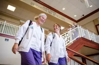 nursing students walking down stairs at the College of Nursing